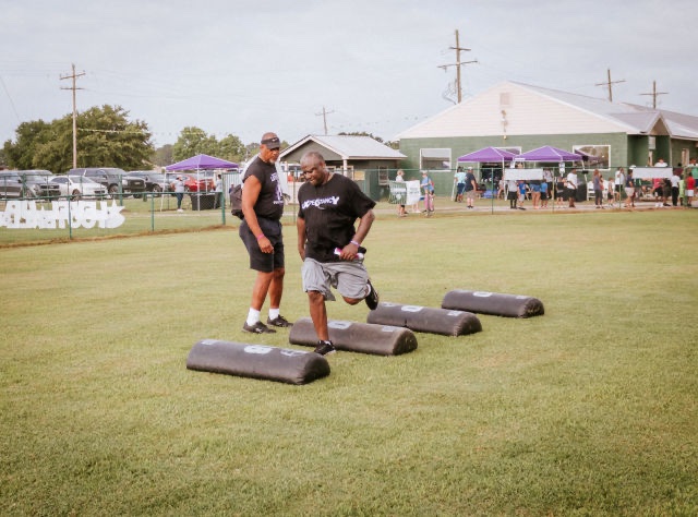 Coach Dad showing the team how he wants things done at Patrick Queen 2022 "level Up" youth football camp