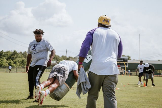 Kids run drills at Patrick Queen 2022 "level Up" youth football camp