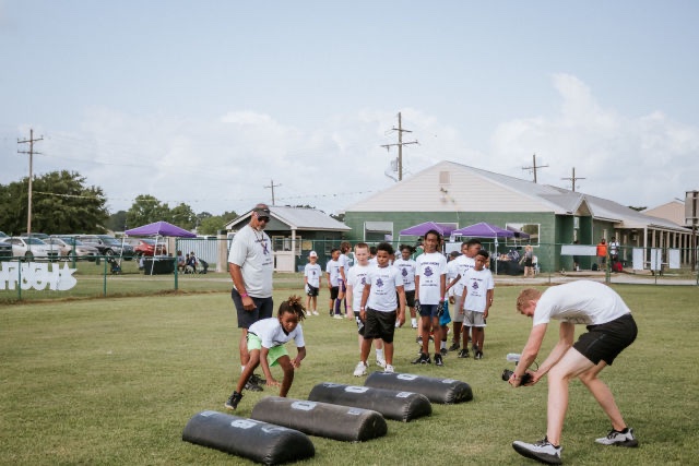 Kids run drills at Patrick Queen 2022 "level Up" youth football camp