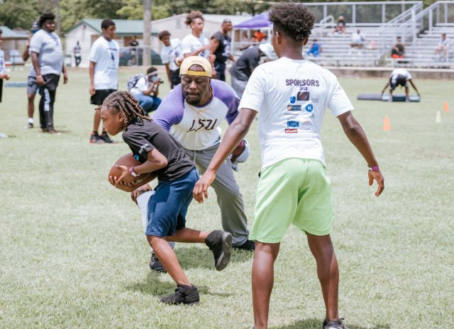 Kids run drills at Patrick Queen 2022 "level Up" youth football camp